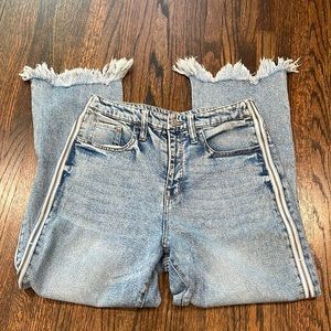 Jeans with side zippers and fringe at the bottom